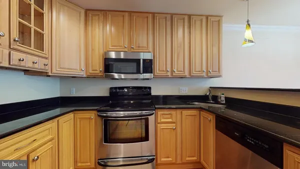a kitchen with granite countertop cabinets and a stove top oven