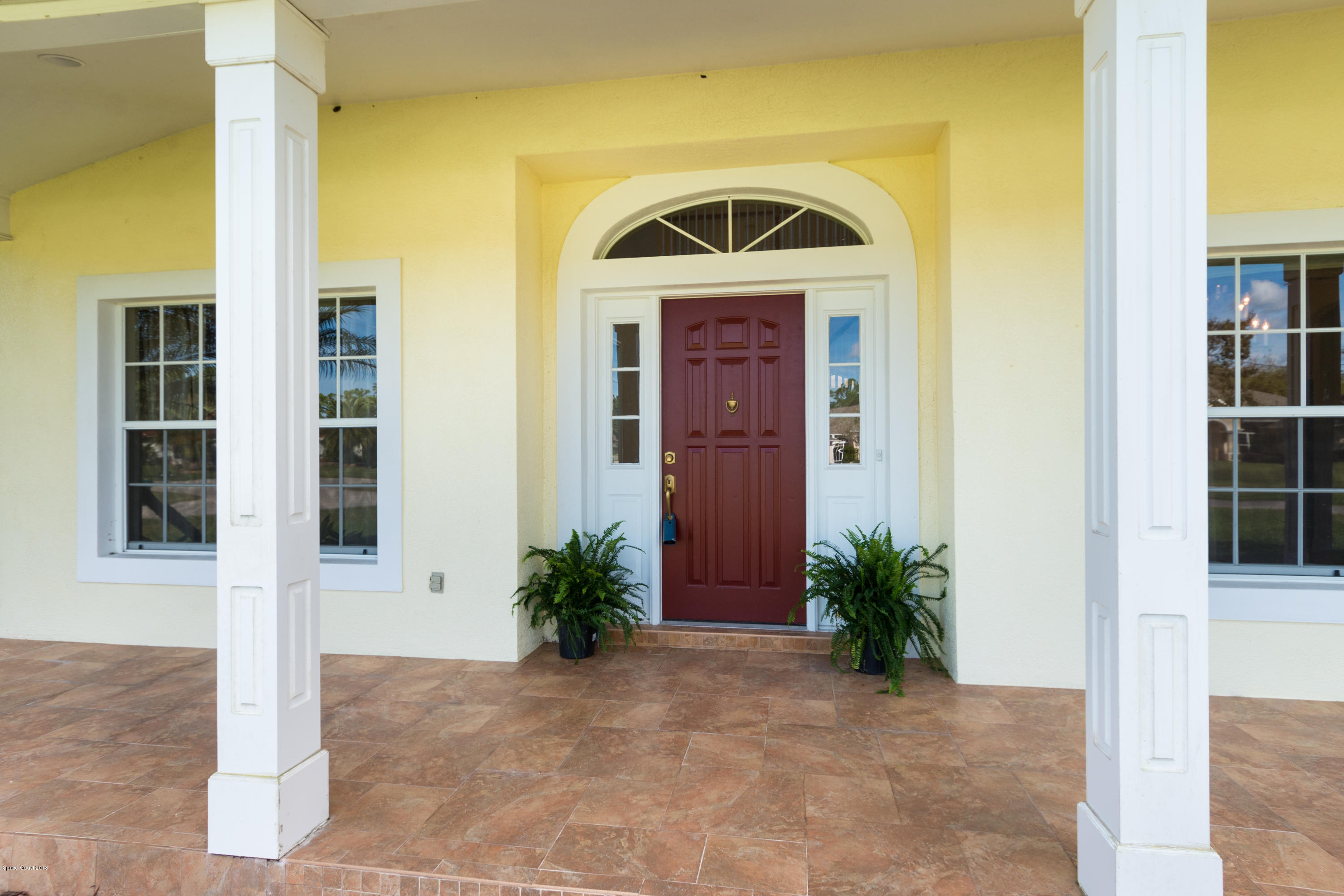 3420 Shady Run Road Melbourne, FL 32934 - Photo 2 of 33 a front view of a house with a yard