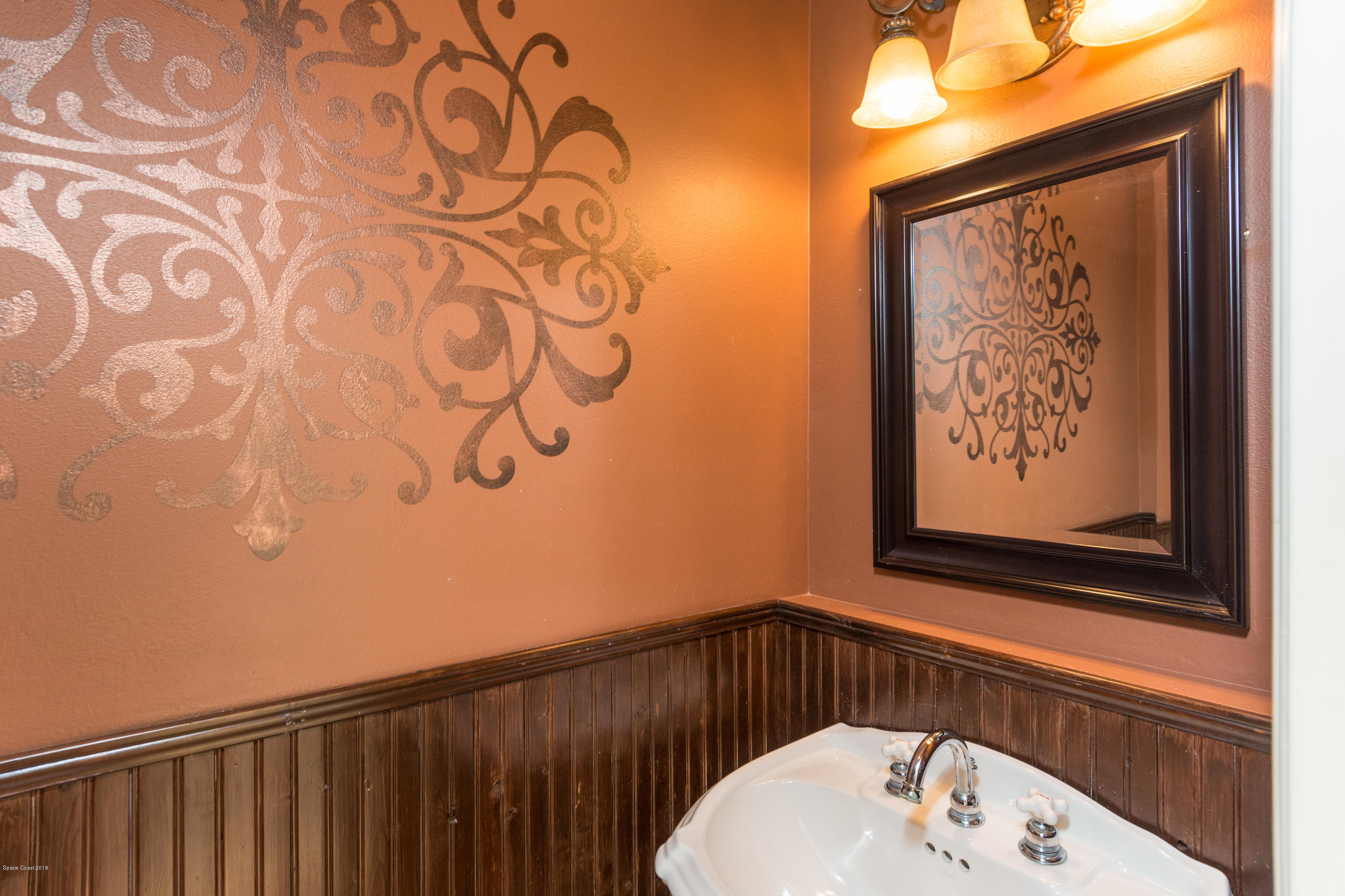 3420 Shady Run Road Melbourne, FL 32934 - Photo 11 of 33 a bathroom with a sink and a mirror