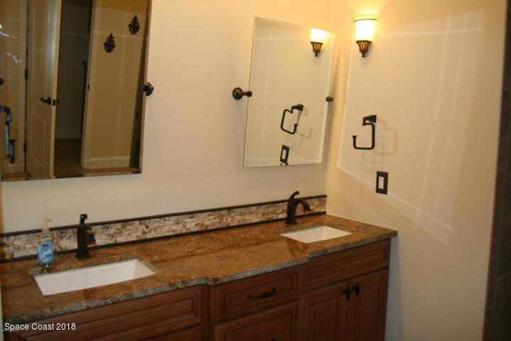 3420 Shady Run Road Melbourne, FL 32934 - Photo 15 of 33 a bathroom with a sink and a mirror