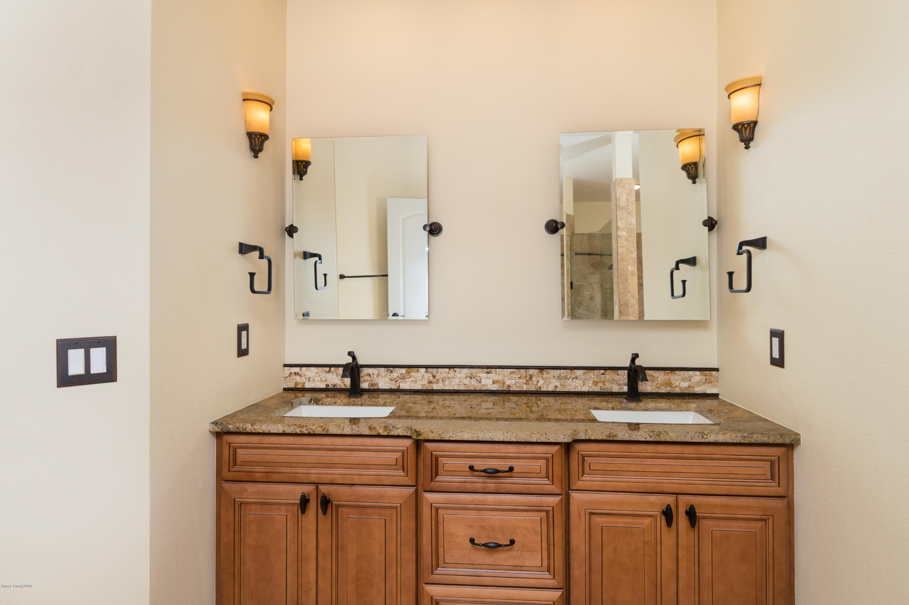 3420 Shady Run Road Melbourne, FL 32934 - Photo 16 of 33 a bathroom with a sink and a mirror