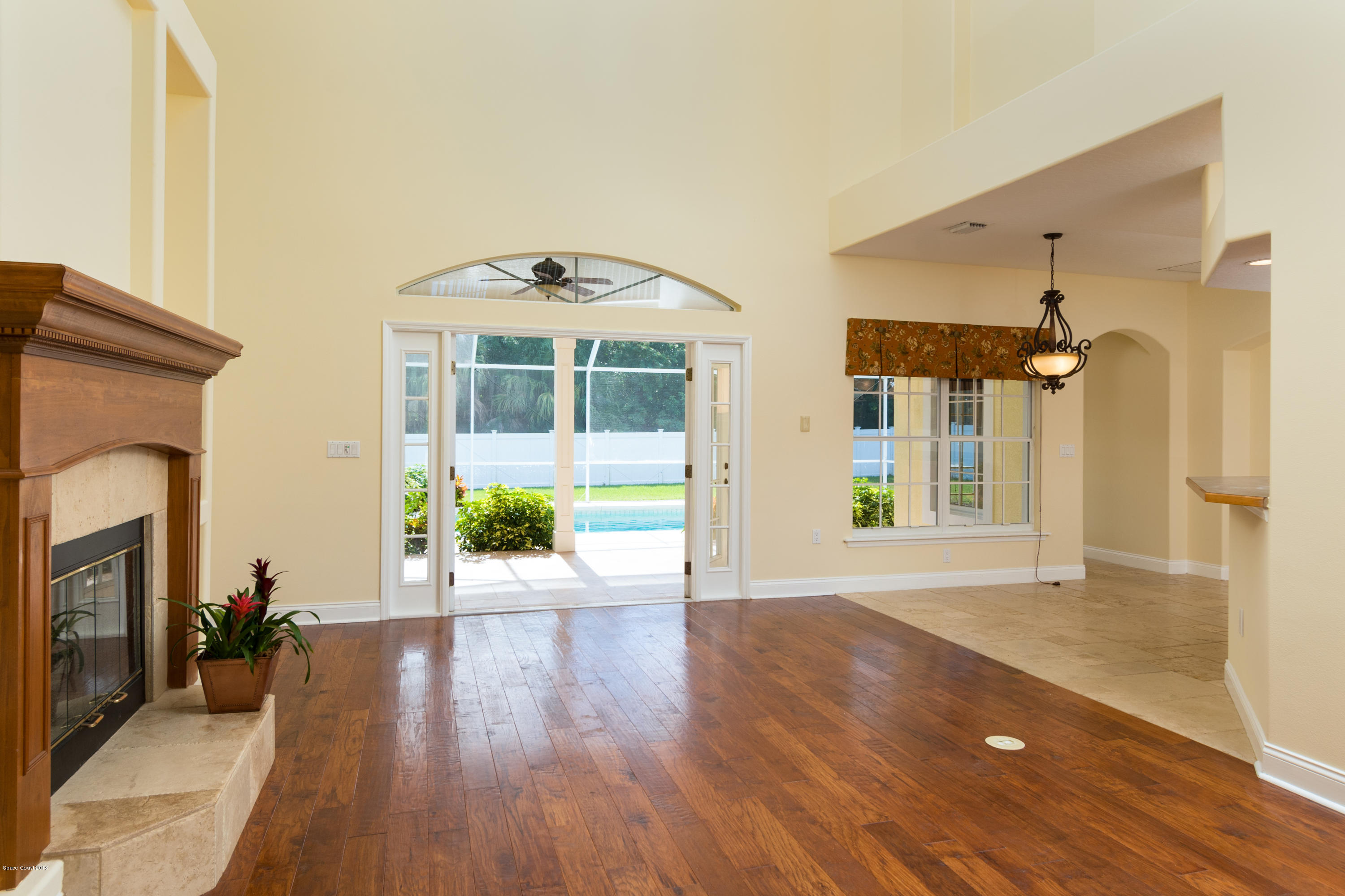 3420 Shady Run Road Melbourne, FL 32934 - Photo 3 of 33 a view of a hallway with wooden floor and a fireplace