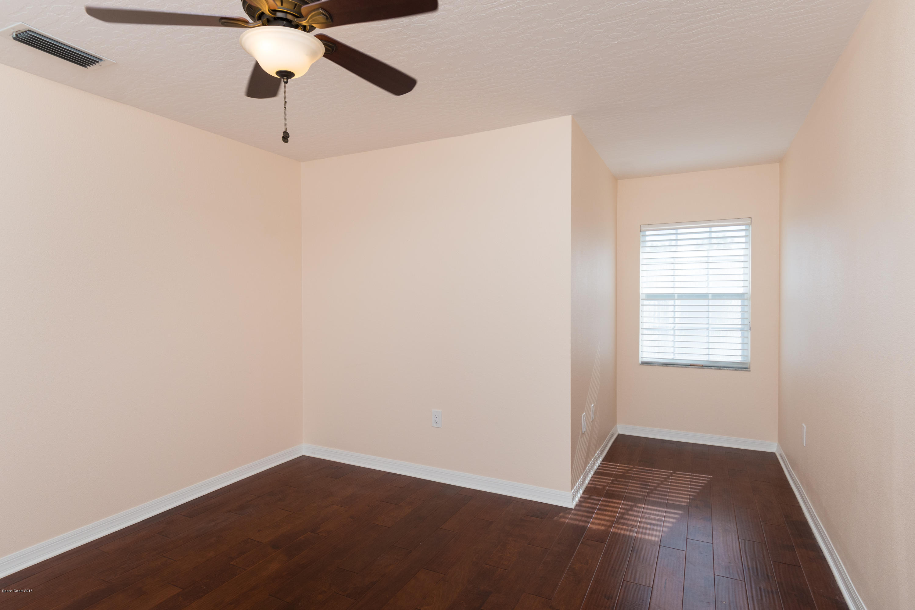 3420 Shady Run Road Melbourne, FL 32934 - Photo 29 of 33 an empty room with a window and a fan