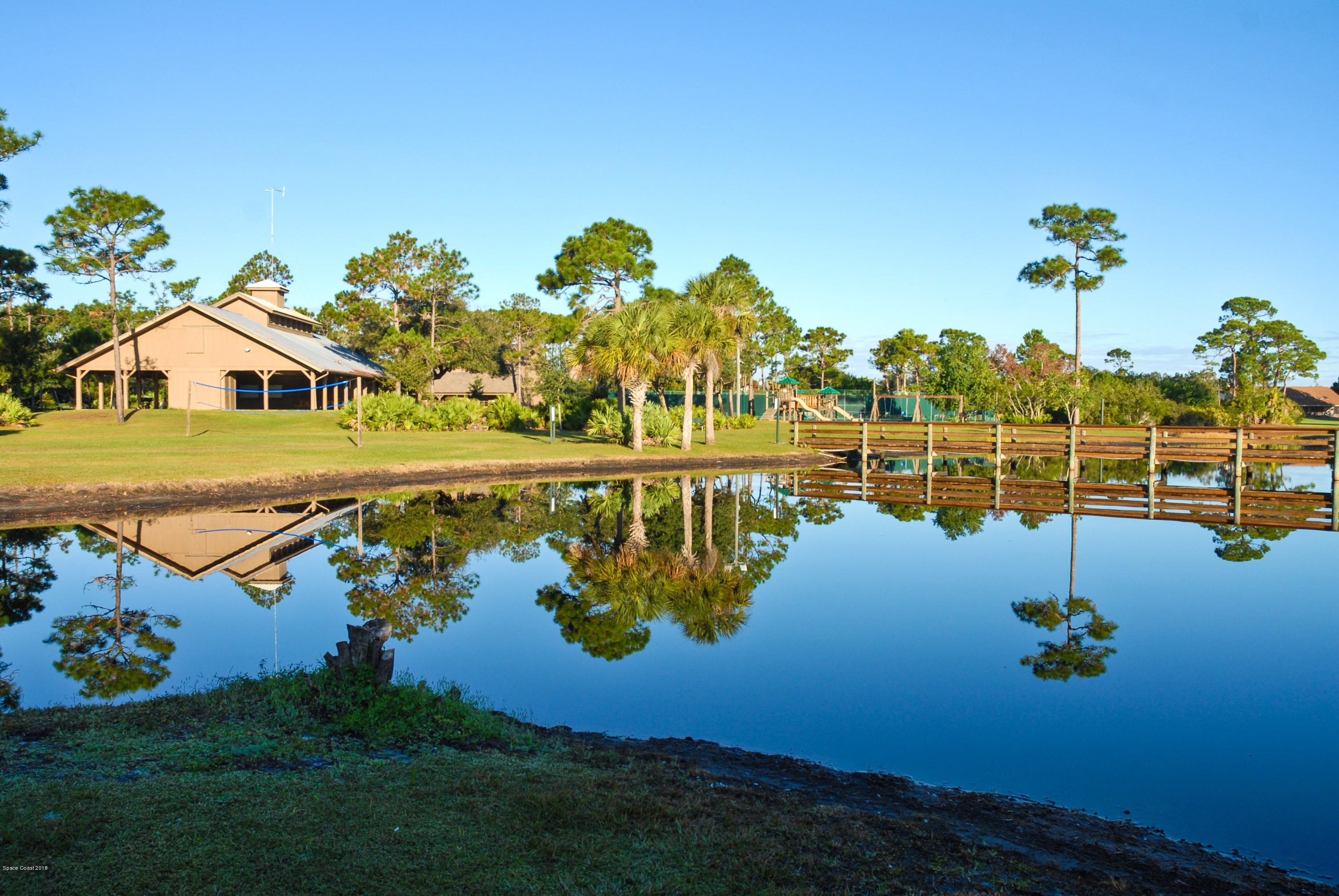 3420 Shady Run Road Melbourne, FL 32934 - Photo 32 of 33 a view of a lake with a house in the background