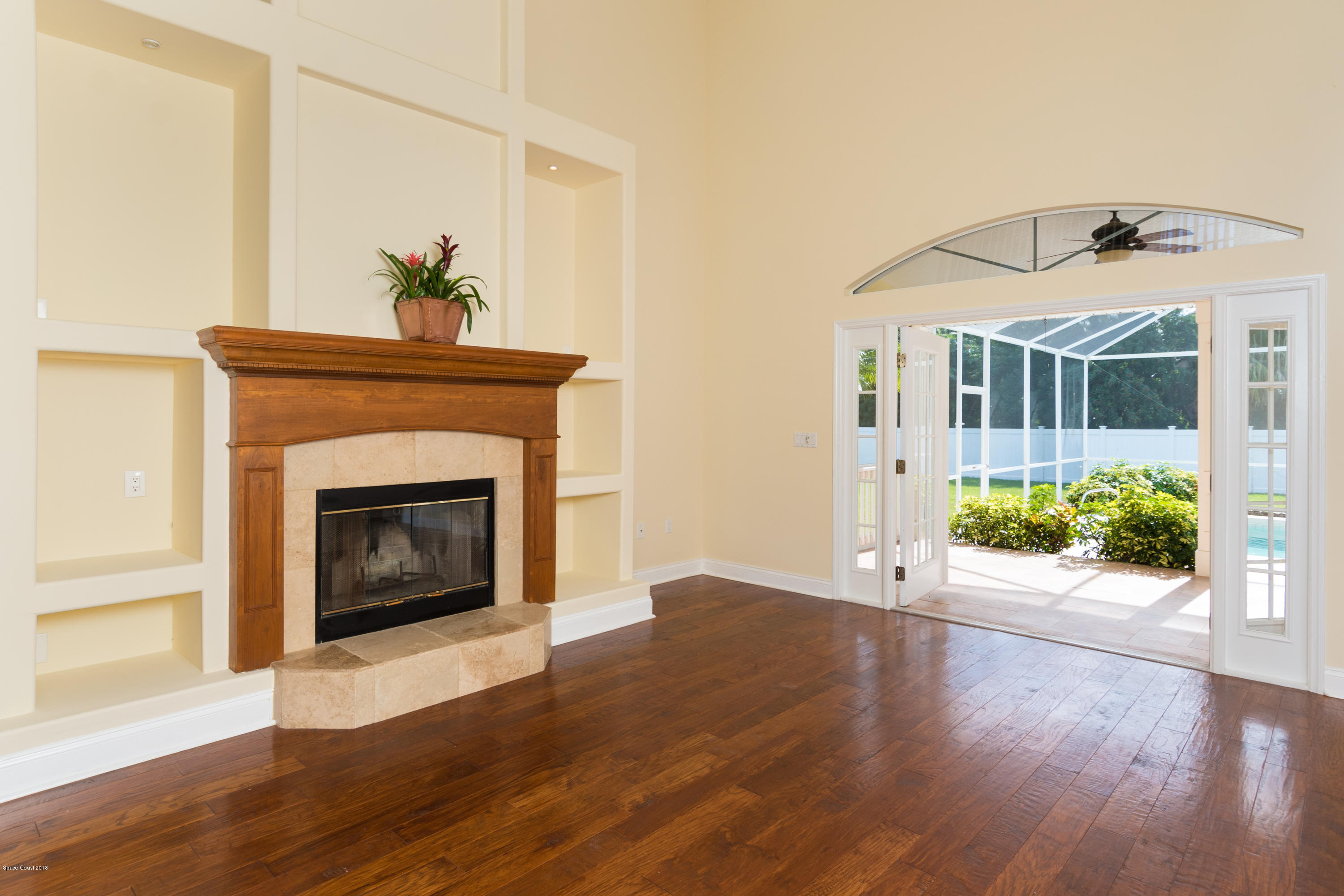 3420 Shady Run Road Melbourne, FL 32934 - Photo 6 of 33 a view of a hallway with wooden floor and a fireplace