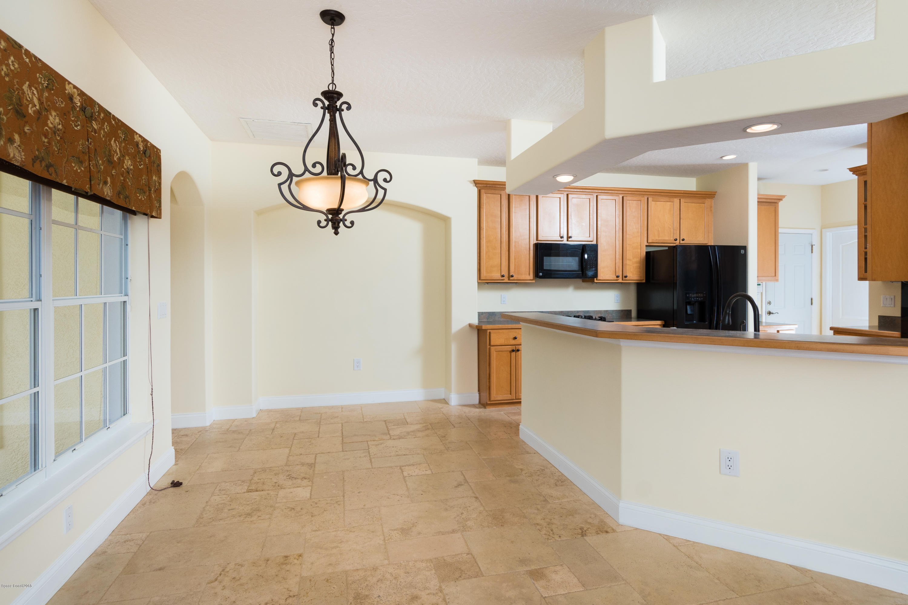 3420 Shady Run Road Melbourne, FL 32934 - Photo 8 of 33 a kitchen with a refrigerator a sink and a window