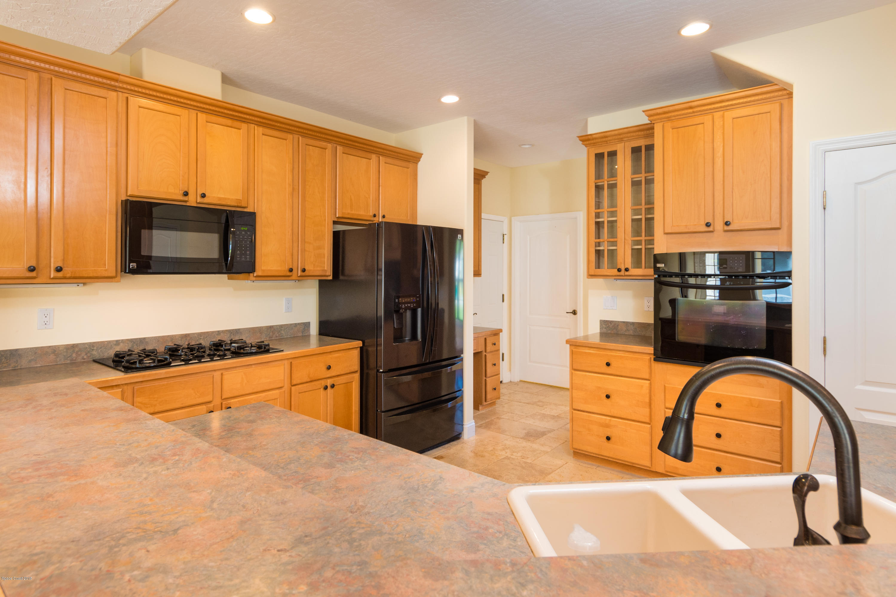 3420 Shady Run Road Melbourne, FL 32934 - Photo 9 of 33 a kitchen with stainless steel appliances granite countertop a refrigerator a stove top oven and a refrigerator with wooden floor