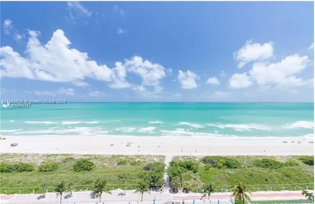 a view of an empty room and kitchen with sink