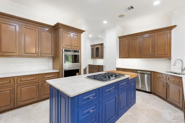 a kitchen with a stove sink and cabinets