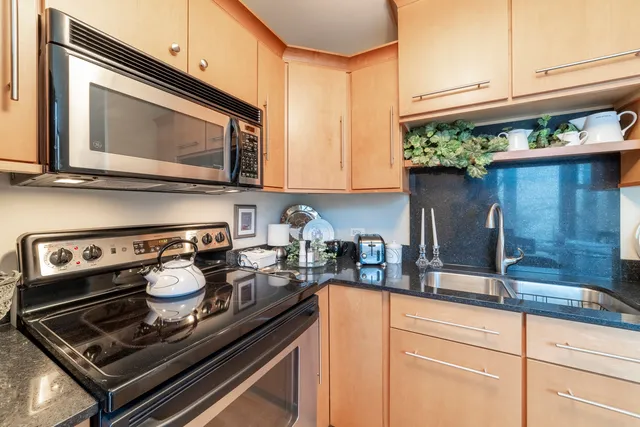 a kitchen with a stove microwave and cabinets