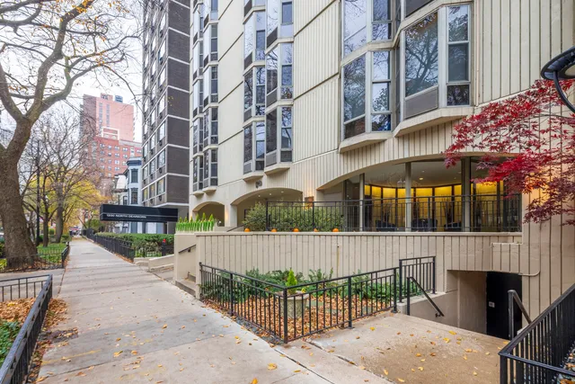 a view of a brick building with a tree in front