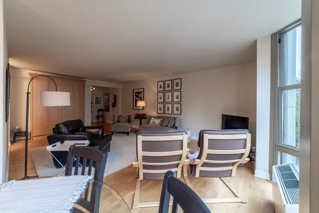 a view of a livingroom with furniture a fireplace and wooden floor