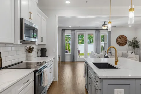 a kitchen with a sink a stove and cabinets
