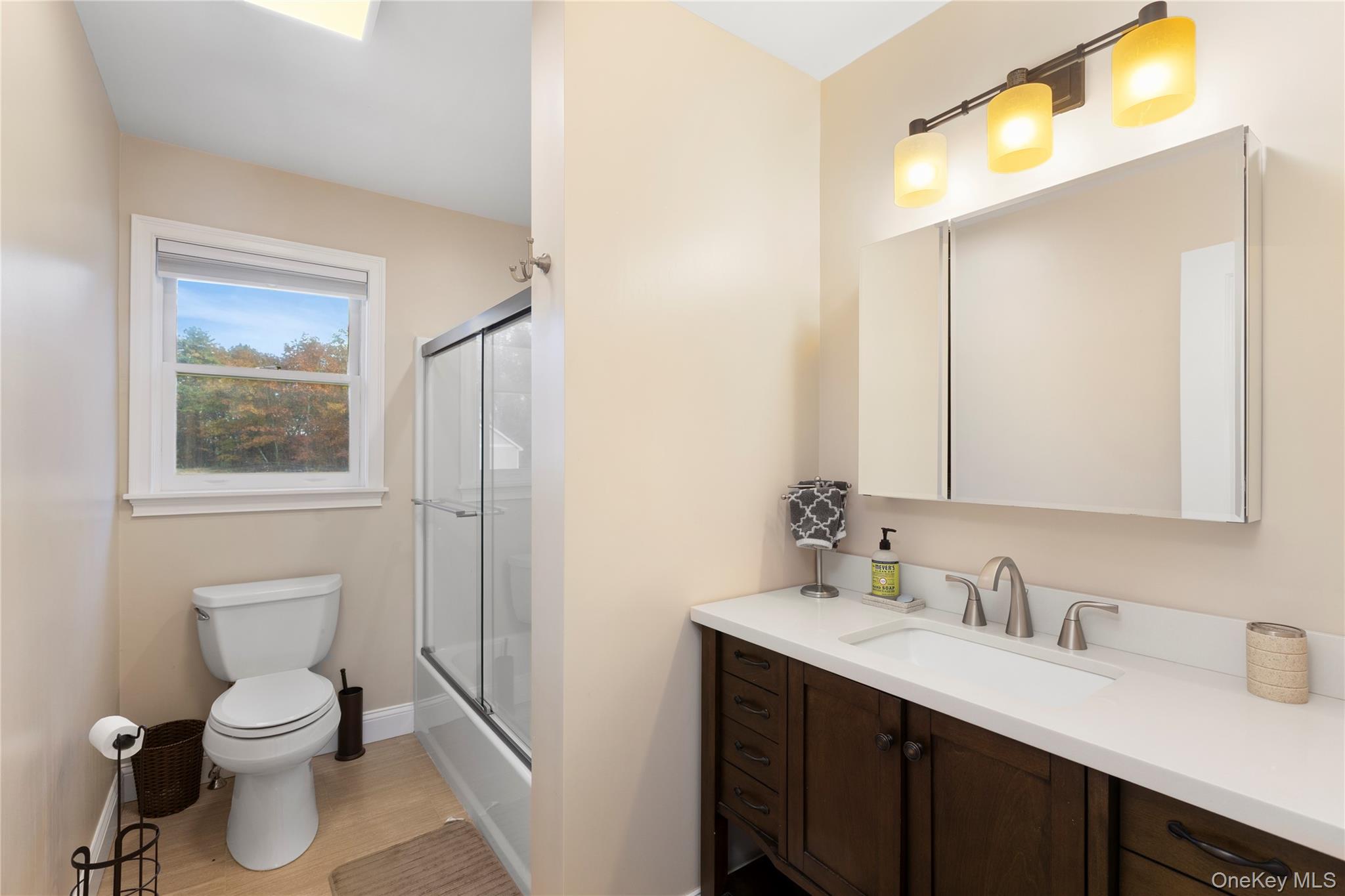 216 N Road Red Hook, NY 12571 - Photo 13 of 20 a bathroom with a toilet sink vanity and mirror