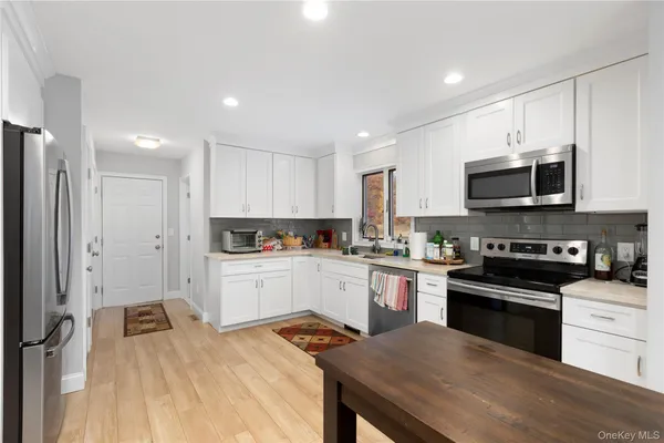 a kitchen with a sink a stove a microwave and cabinets