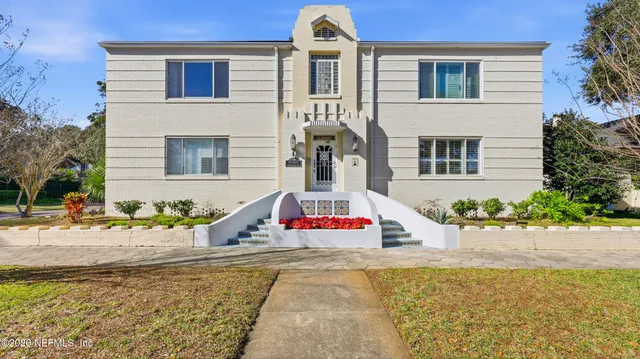 a front view of a house with swimming pool and glass windows