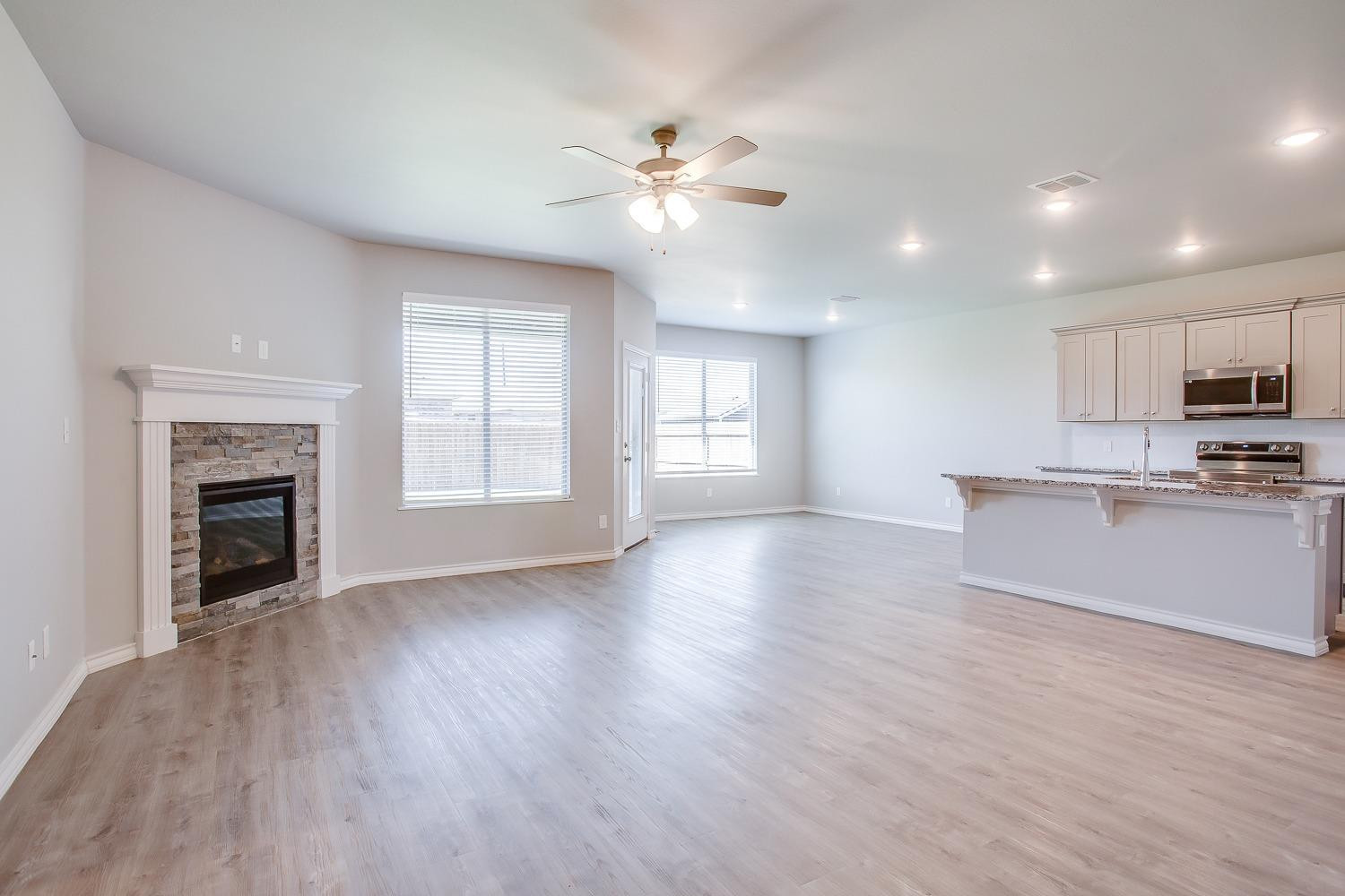 5804 Winfield Avenue Lubbock, TX 79407 - Photo 2 of 18 a view of an empty room with window and wooden floor