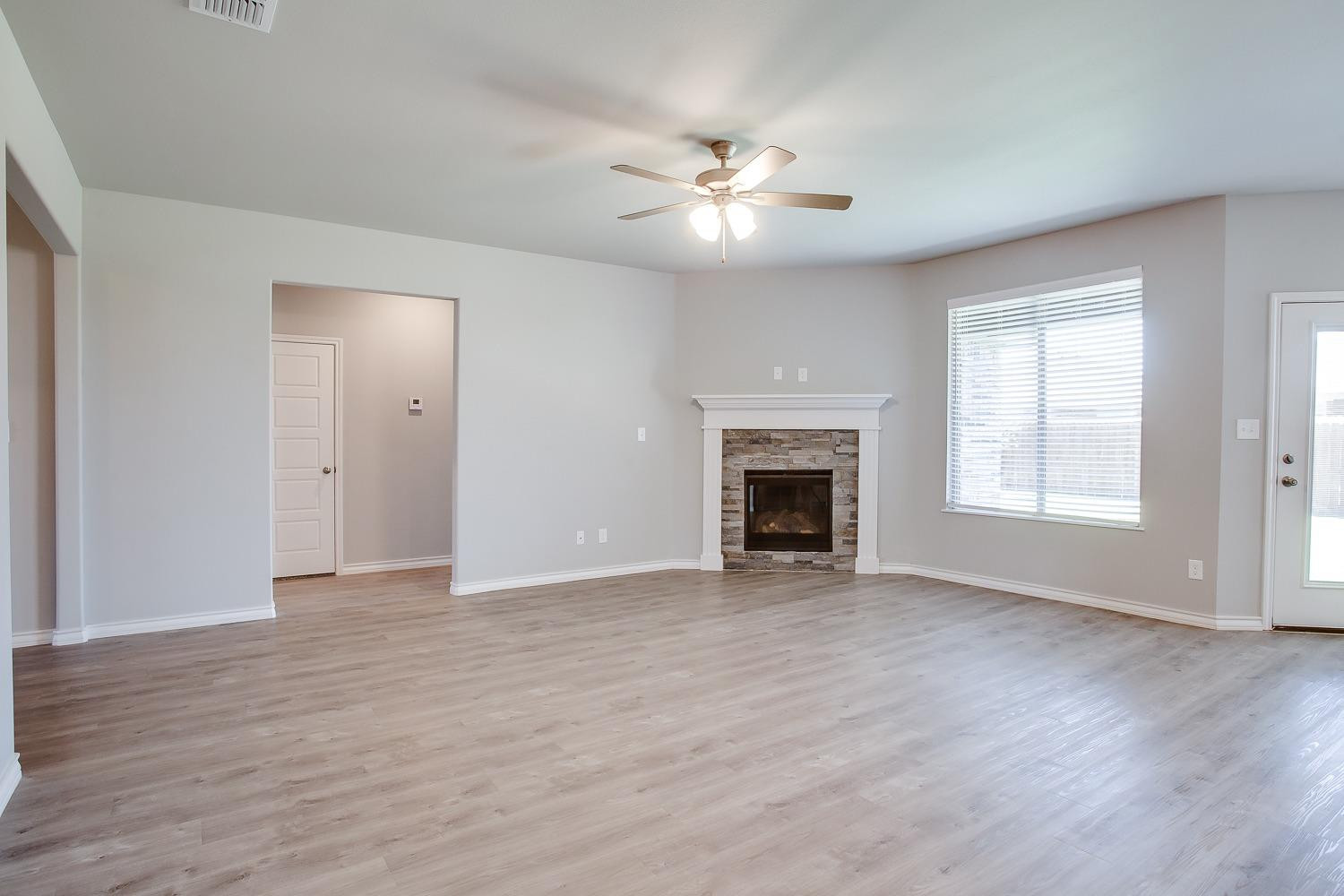 5804 Winfield Avenue Lubbock, TX 79407 - Photo 3 of 18 a view of an empty room with wooden floor and a window