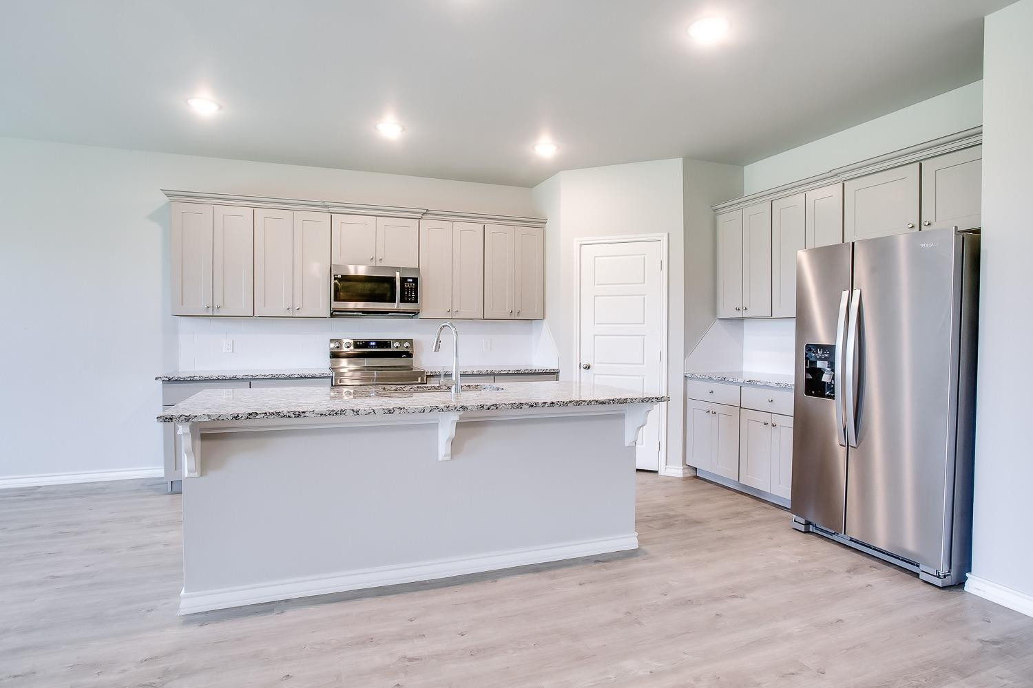 5804 Winfield Avenue Lubbock, TX 79407 - Photo 5 of 18 a kitchen with kitchen island a white cabinets and refrigerator