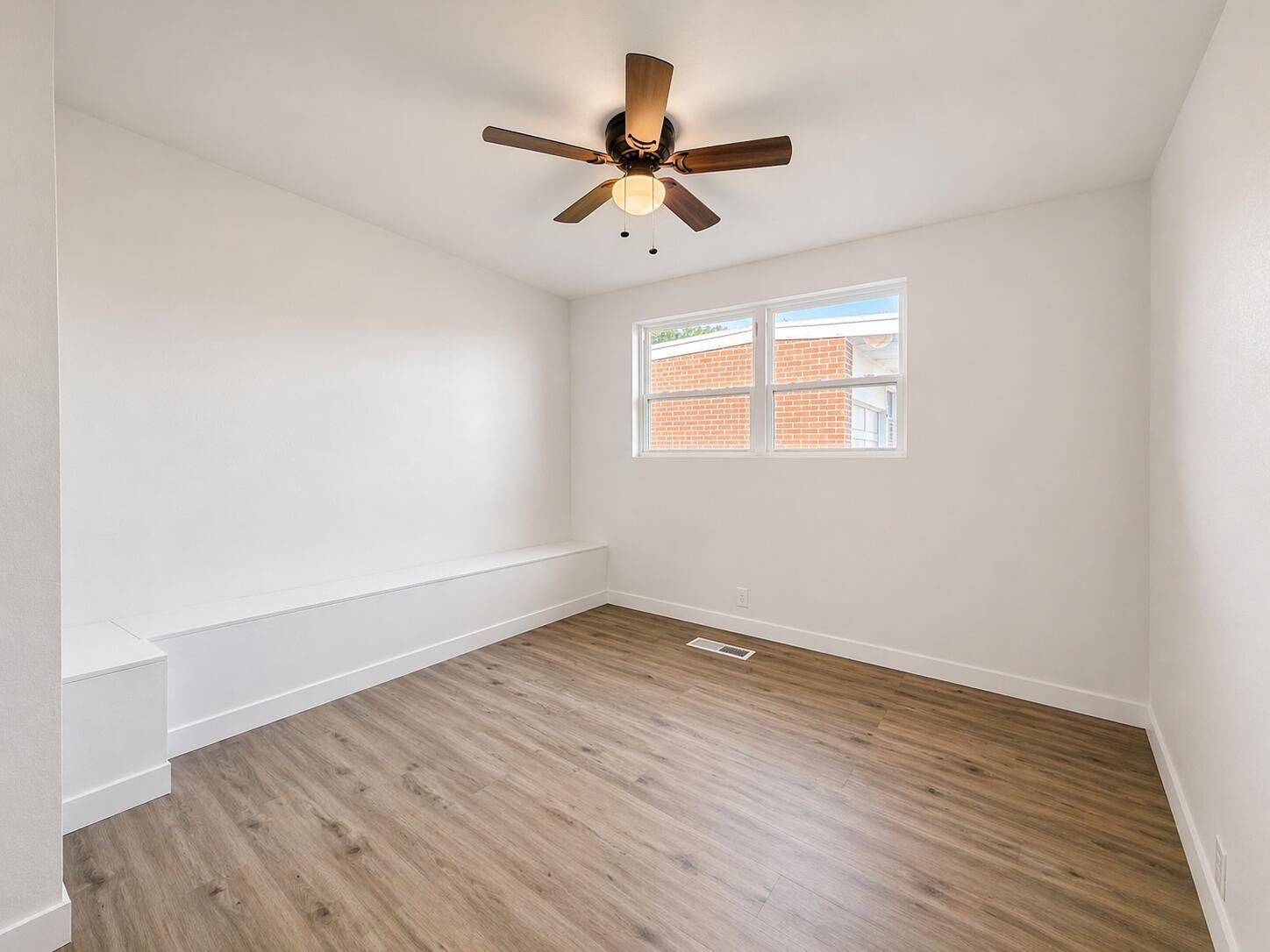 2316 48th Street Lubbock, TX 79412 - Photo 9 of 18 an empty room with wooden floor and windows