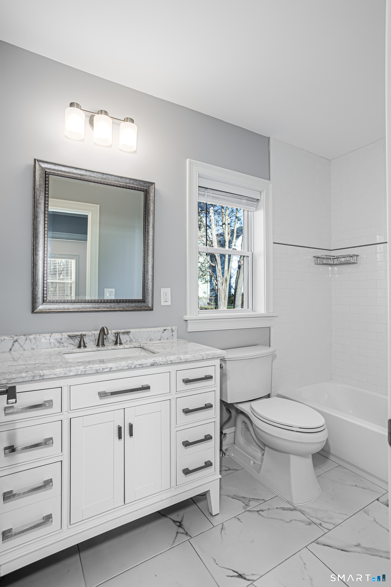 65 Mason Street Fairfield, CT 06825 - Photo 11 of 30 a bathroom with a toilet sink and mirror