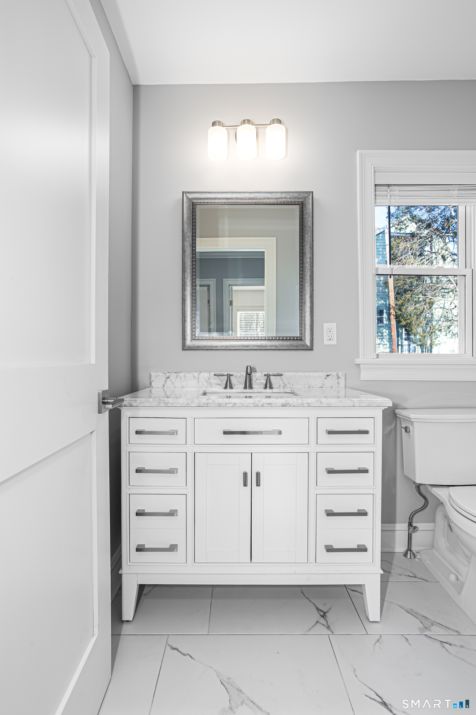 65 Mason Street Fairfield, CT 06825 - Photo 12 of 30 a bathroom with a sink vanity and mirror
