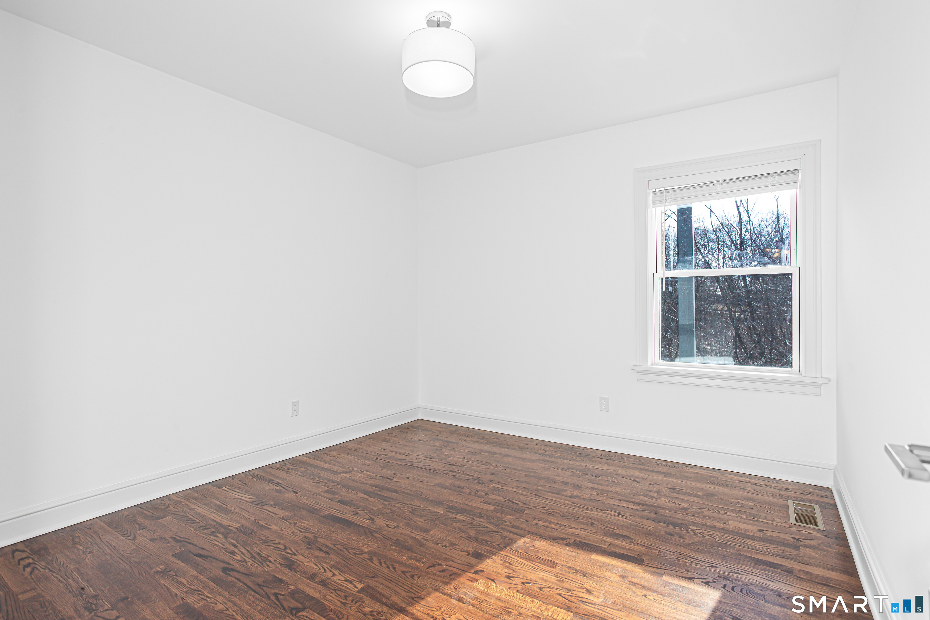 65 Mason Street Fairfield, CT 06825 - Photo 15 of 30 an empty room with wooden floor and windows