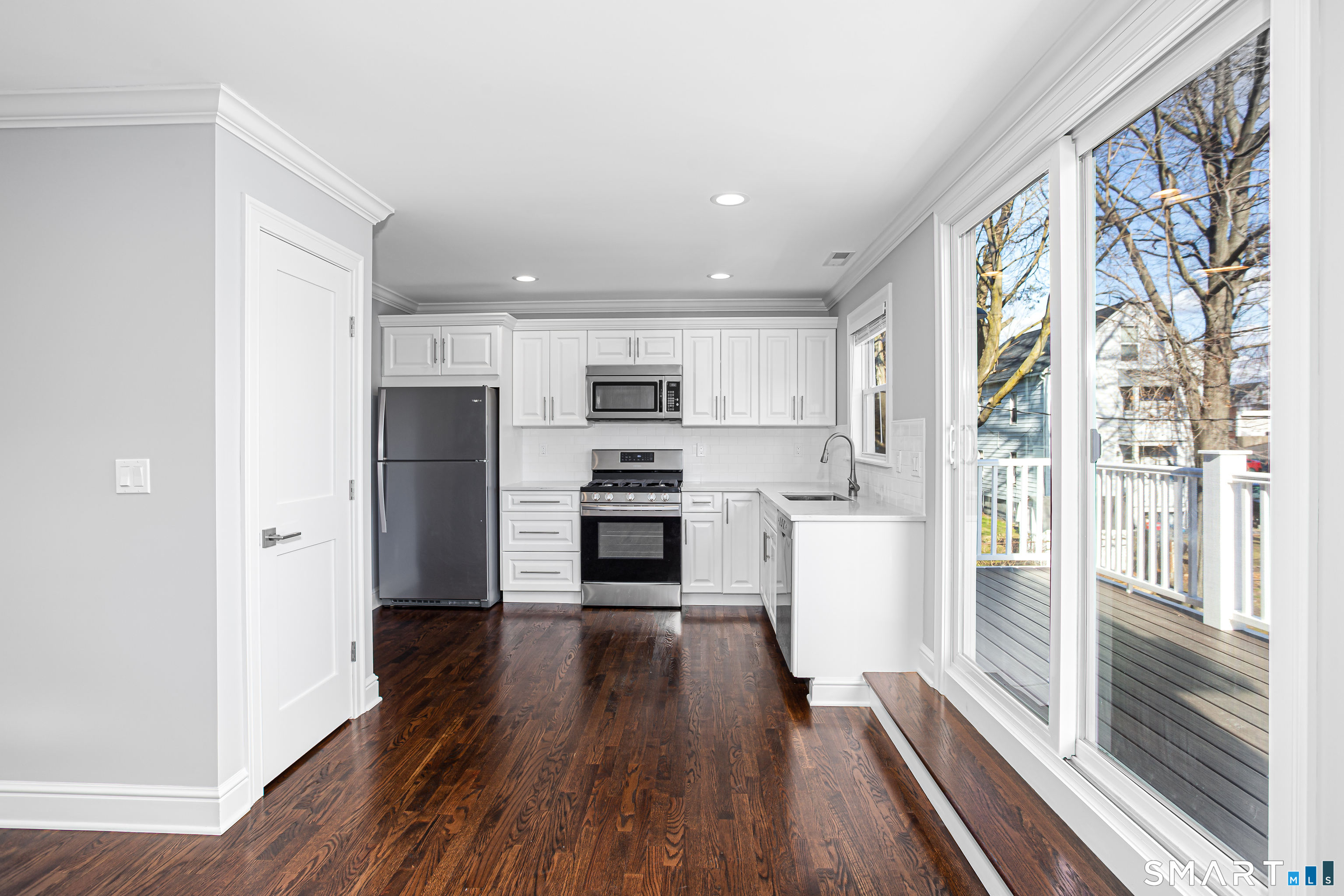 65 Mason Street Fairfield, CT 06825 - Photo 19 of 30 a kitchen with stainless steel appliances a refrigerator and wooden floor