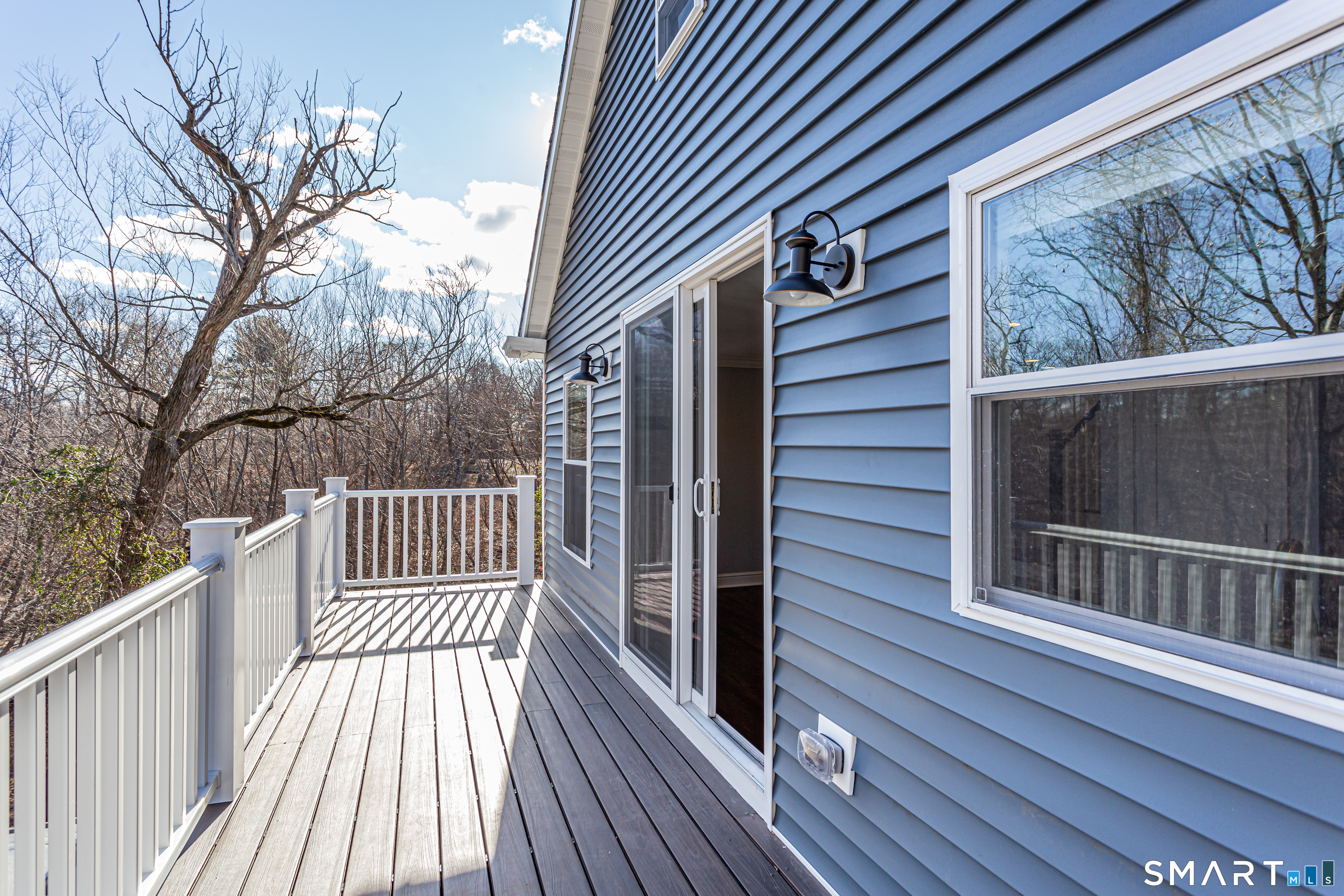 65 Mason Street Fairfield, CT 06825 - Photo 21 of 30 a view of a wooden balcony and trees