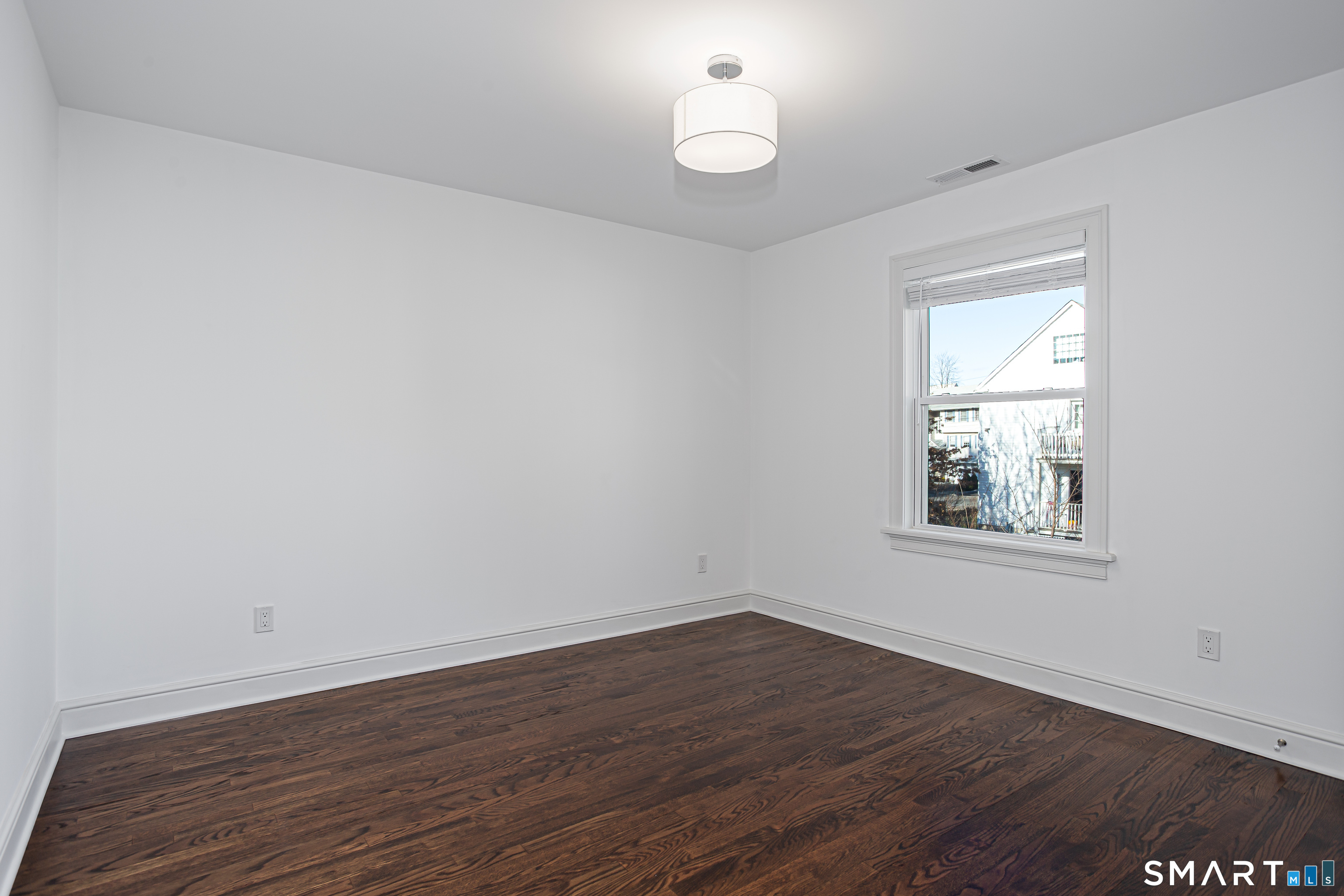 65 Mason Street Fairfield, CT 06825 - Photo 26 of 30 wooden floor in an empty room with a window