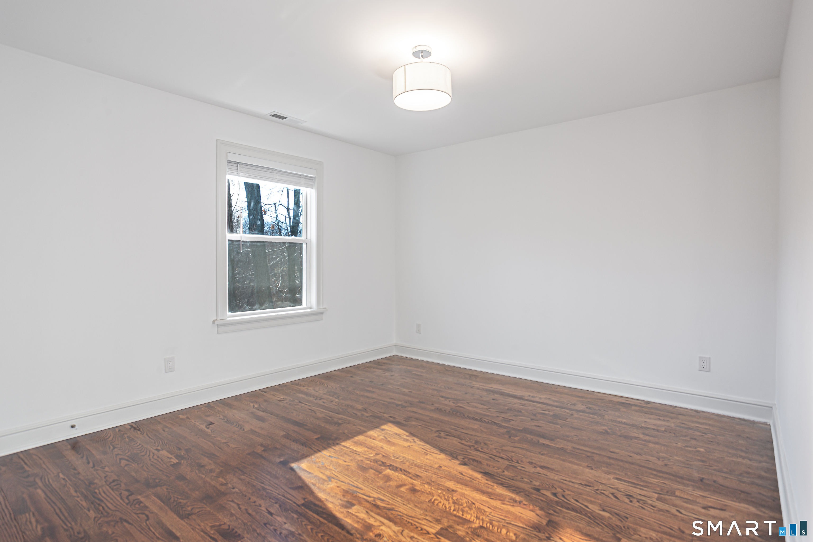65 Mason Street Fairfield, CT 06825 - Photo 27 of 30 wooden floor in an empty room with a window