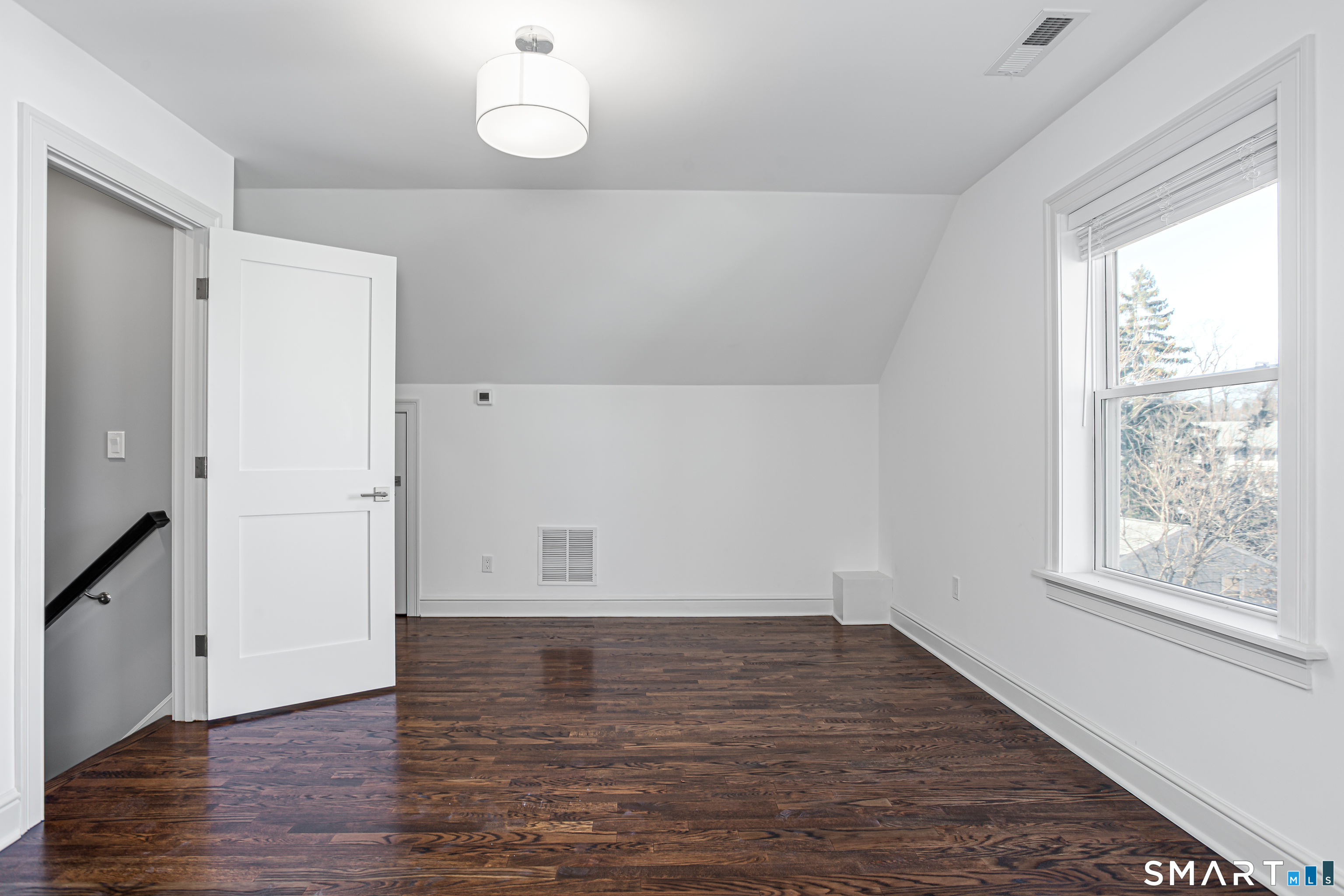 65 Mason Street Fairfield, CT 06825 - Photo 28 of 30 an empty room with wooden floor and windows
