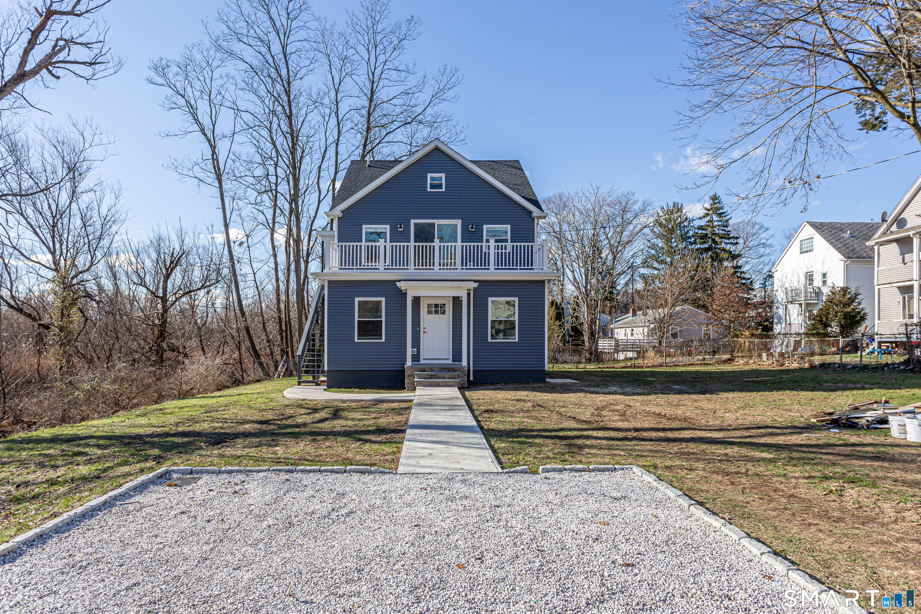 65 Mason Street Fairfield, CT 06825 - Photo 5 of 30 a front view of a house with a yard