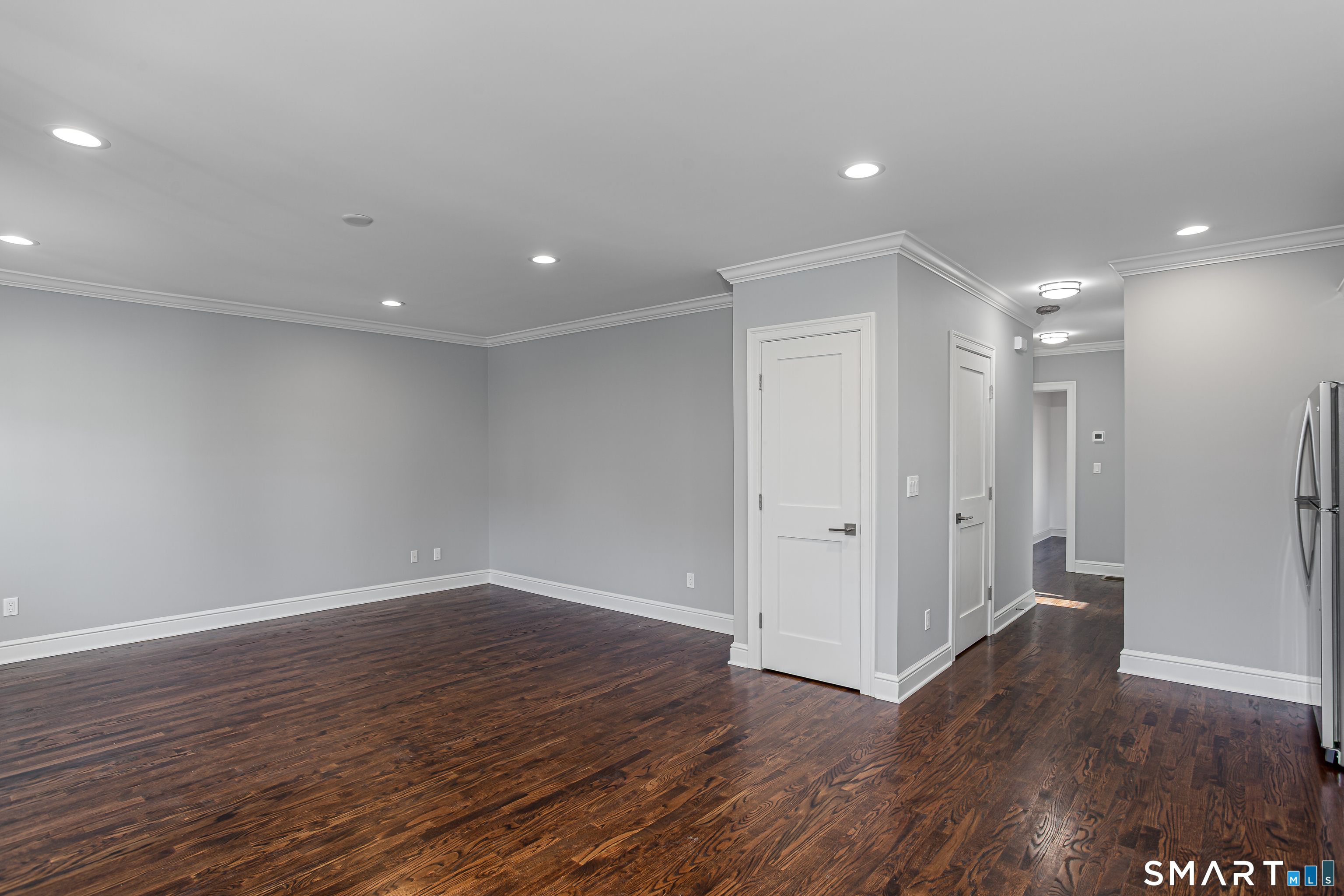 65 Mason Street Fairfield, CT 06825 - Photo 7 of 30 a view of an empty room with wooden floor