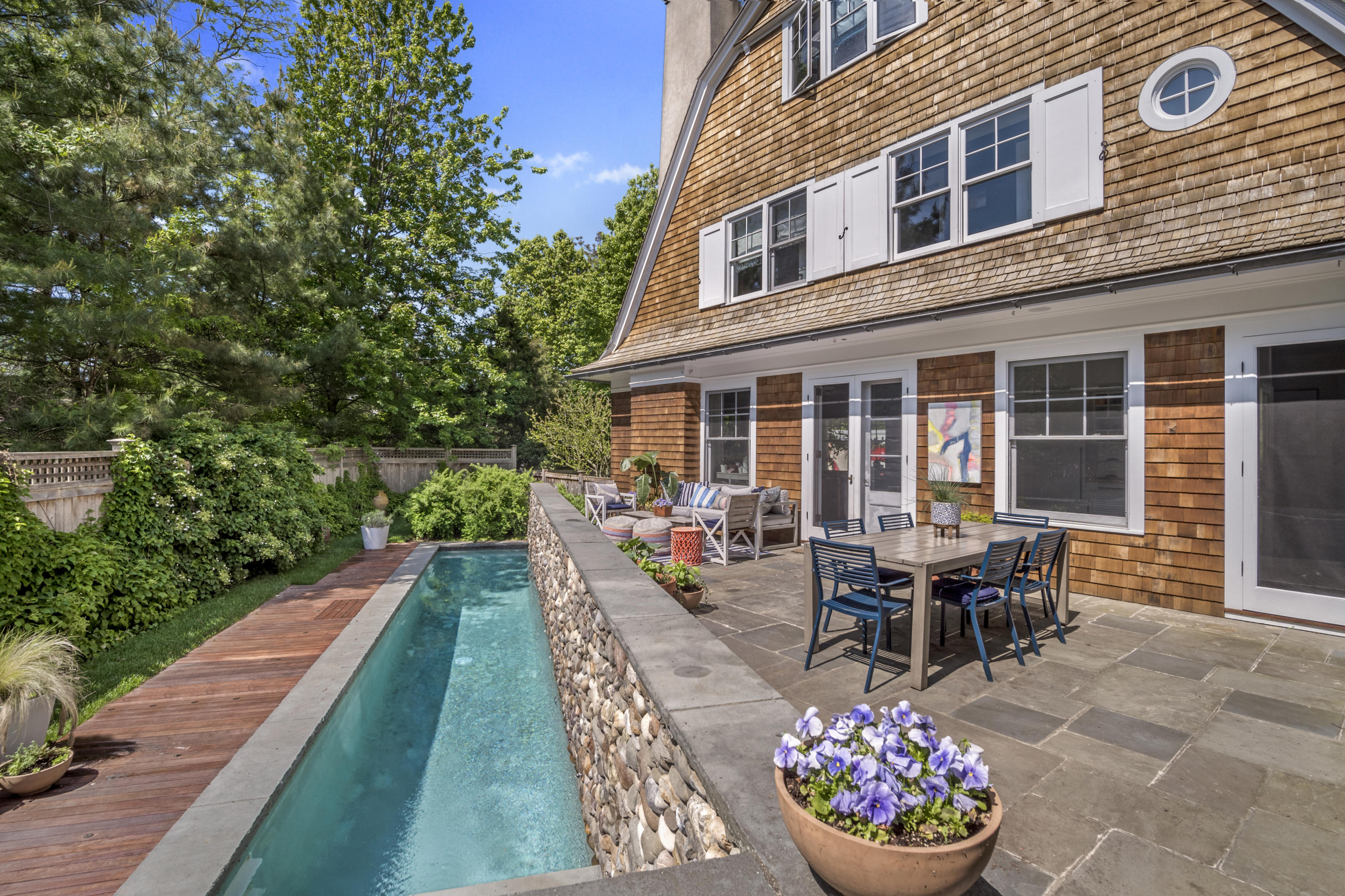a view of a patio with chairs and potted plants