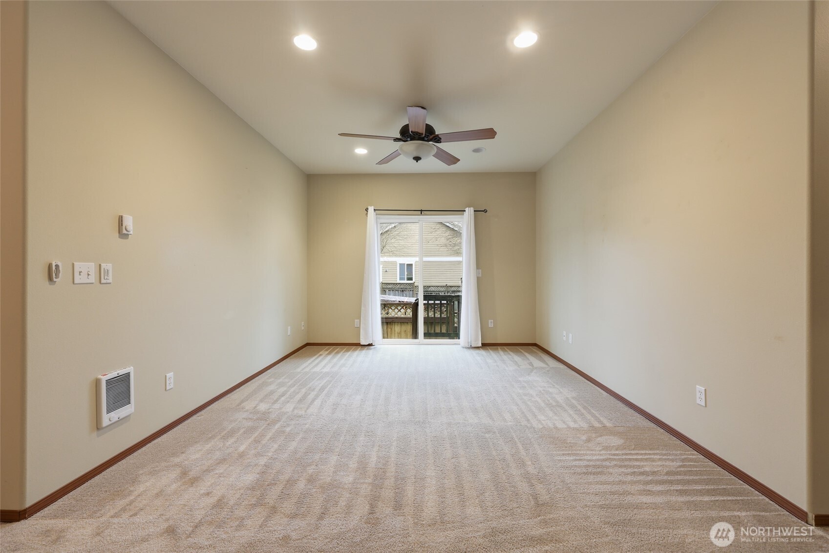 5107 66th Avenue Southeast Lacey, WA 98513 - Photo 11 of 27 an empty room with windows and chandelier fan