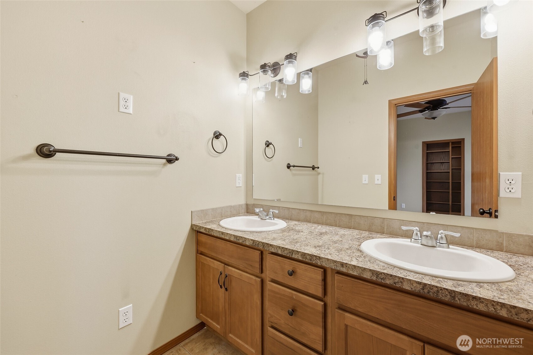 5107 66th Avenue Southeast Lacey, WA 98513 - Photo 14 of 27 a bathroom with a granite countertop sink a mirror and a shower