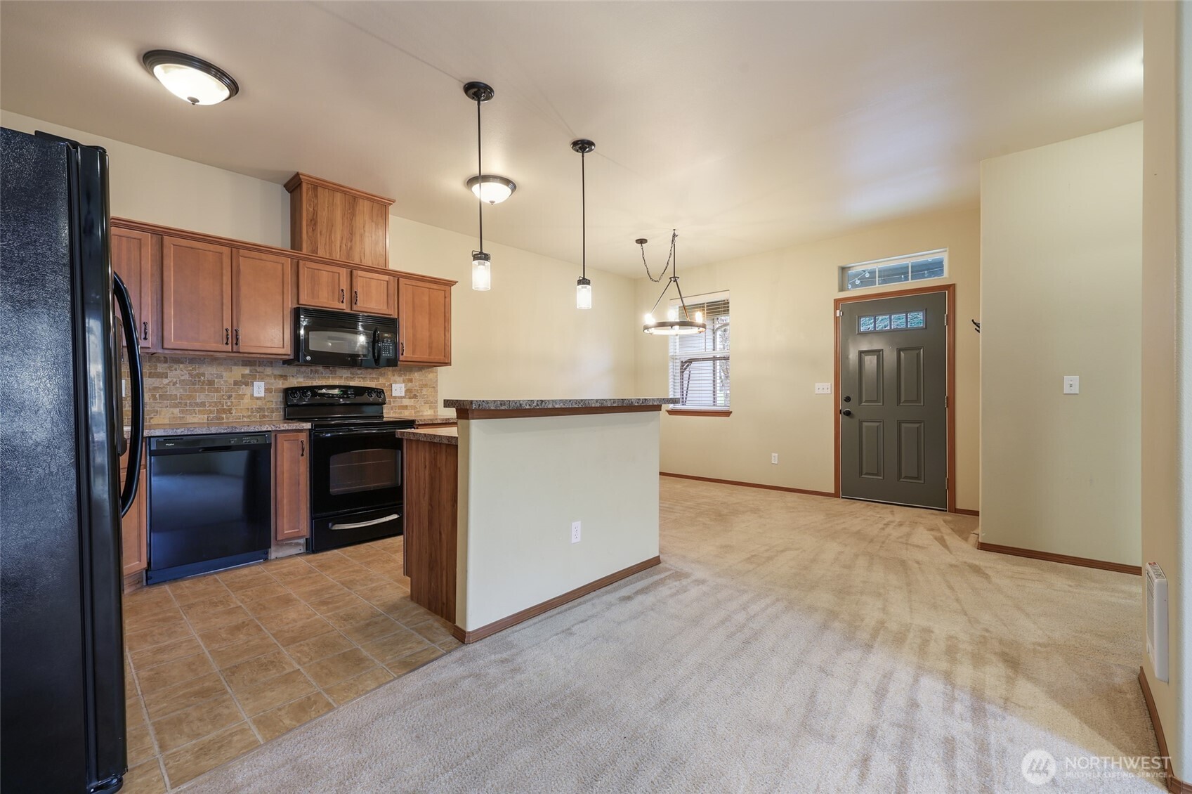 5107 66th Avenue Southeast Lacey, WA 98513 - Photo 18 of 27 a kitchen with kitchen island a counter top space stainless steel appliances and cabinets