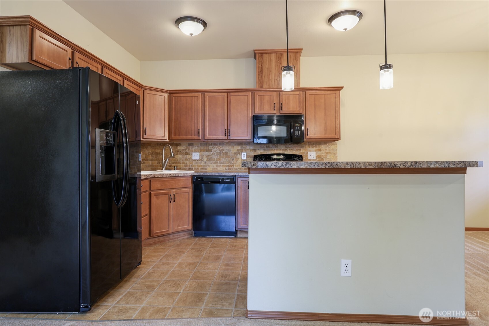 5107 66th Avenue Southeast Lacey, WA 98513 - Photo 19 of 27 a kitchen with stainless steel appliances granite countertop a refrigerator a sink dishwasher a stove and a microwave