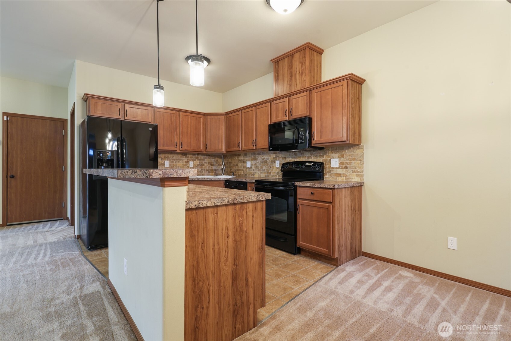 5107 66th Avenue Southeast Lacey, WA 98513 - Photo 20 of 27 a kitchen with stainless steel appliances granite countertop a refrigerator a stove a sink and a microwave
