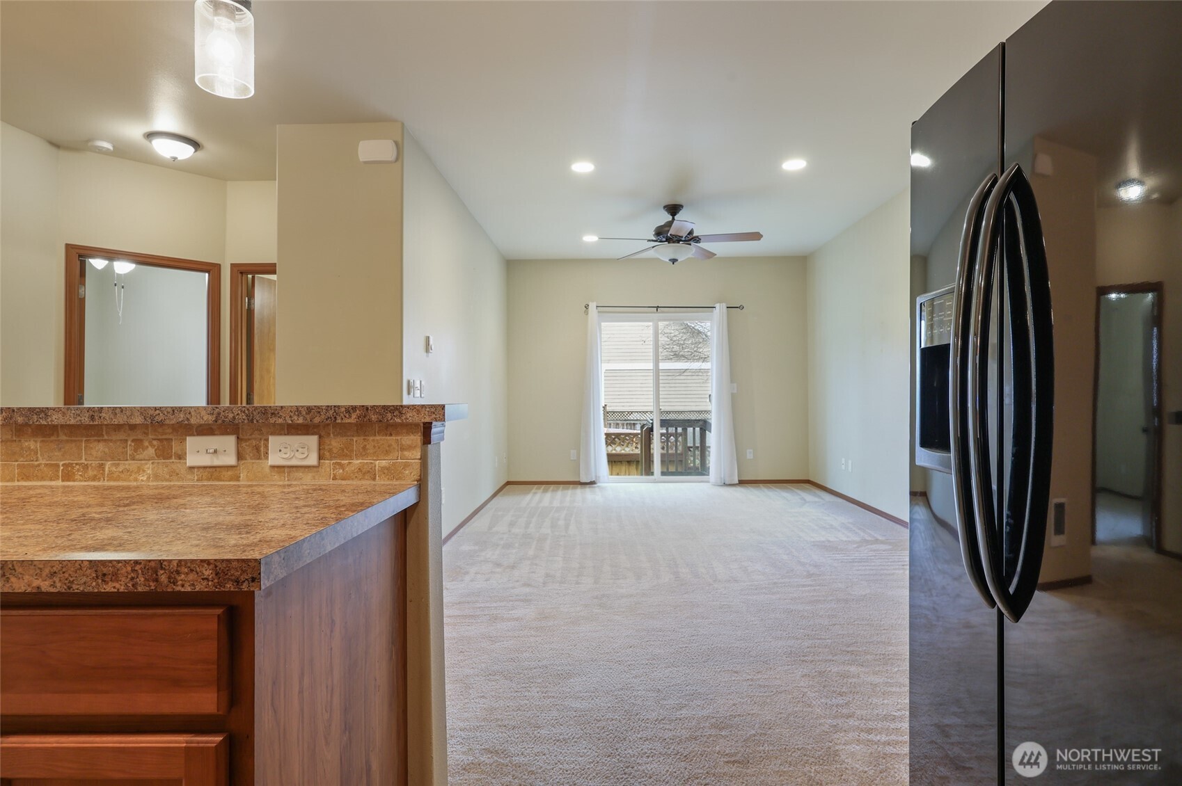 5107 66th Avenue Southeast Lacey, WA 98513 - Photo 22 of 27 a view of a kitchen with a sink and a large mirror