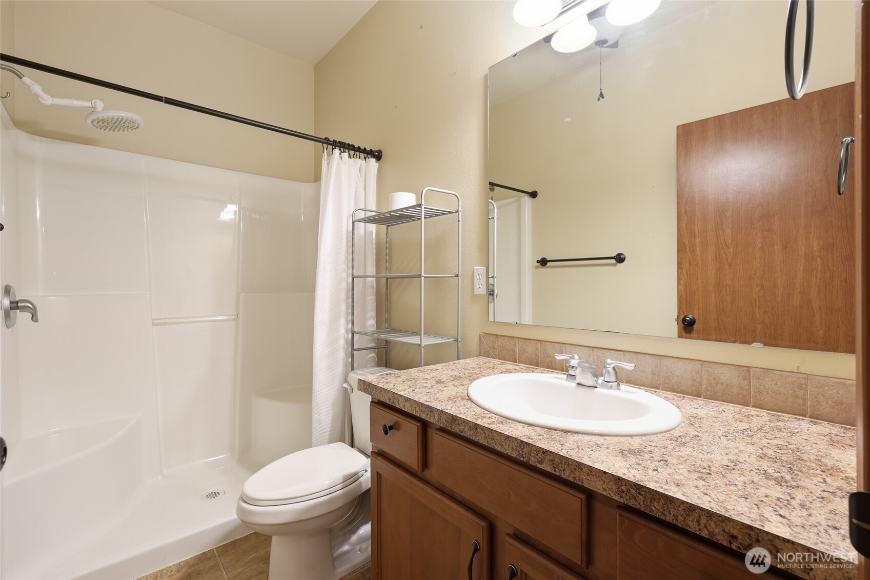 5107 66th Avenue Southeast Lacey, WA 98513 - Photo 9 of 27 a bathroom with a granite countertop sink toilet and shower