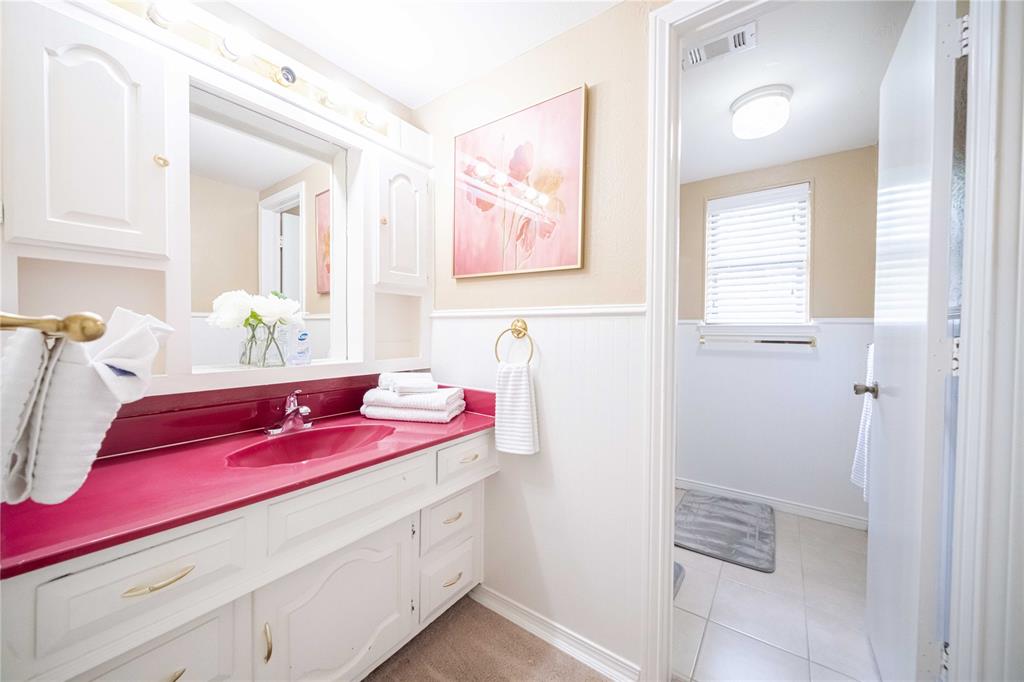 919 Green Hills Road Duncanville, TX 75137 - Photo 26 of 37 Bathroom featuring vanity, a wainscoted wall, and tile patterned flooring