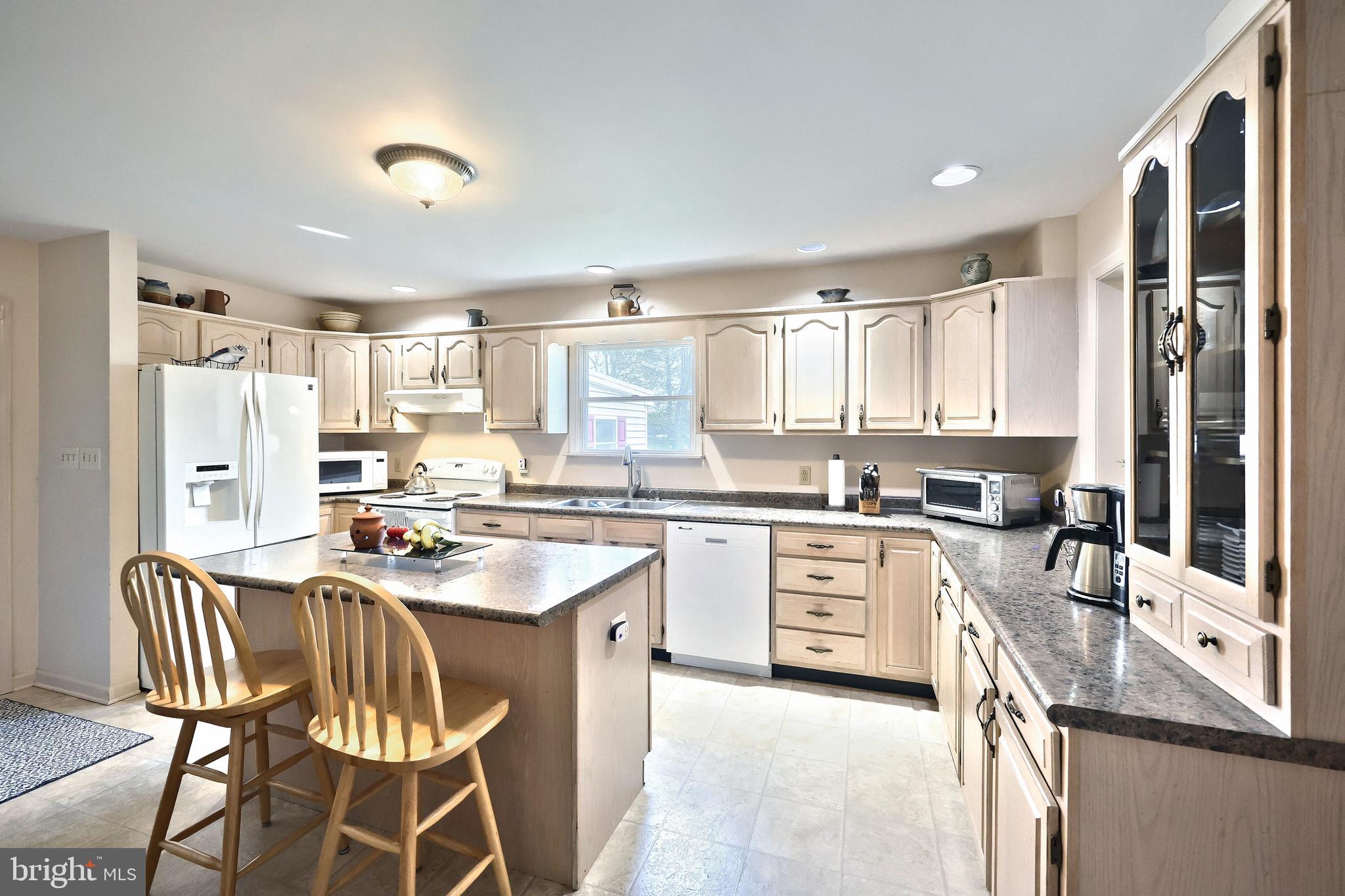 355 Sachs Road Gettysburg, PA 17325 - Photo 12 of 49 a kitchen with stainless steel appliances granite countertop a stove a sink dishwasher a refrigerator with a dining table and chairs