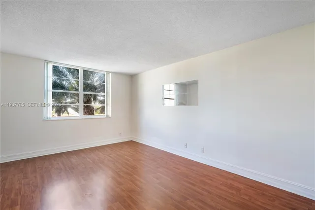 a view of a room with wooden floor and windows