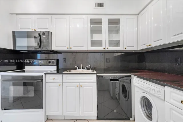 a view of a kitchen with washer and dryer