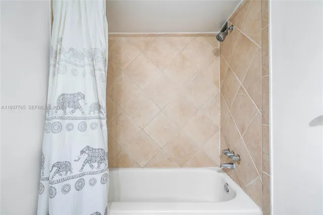 a bathroom with a bathtub and shower