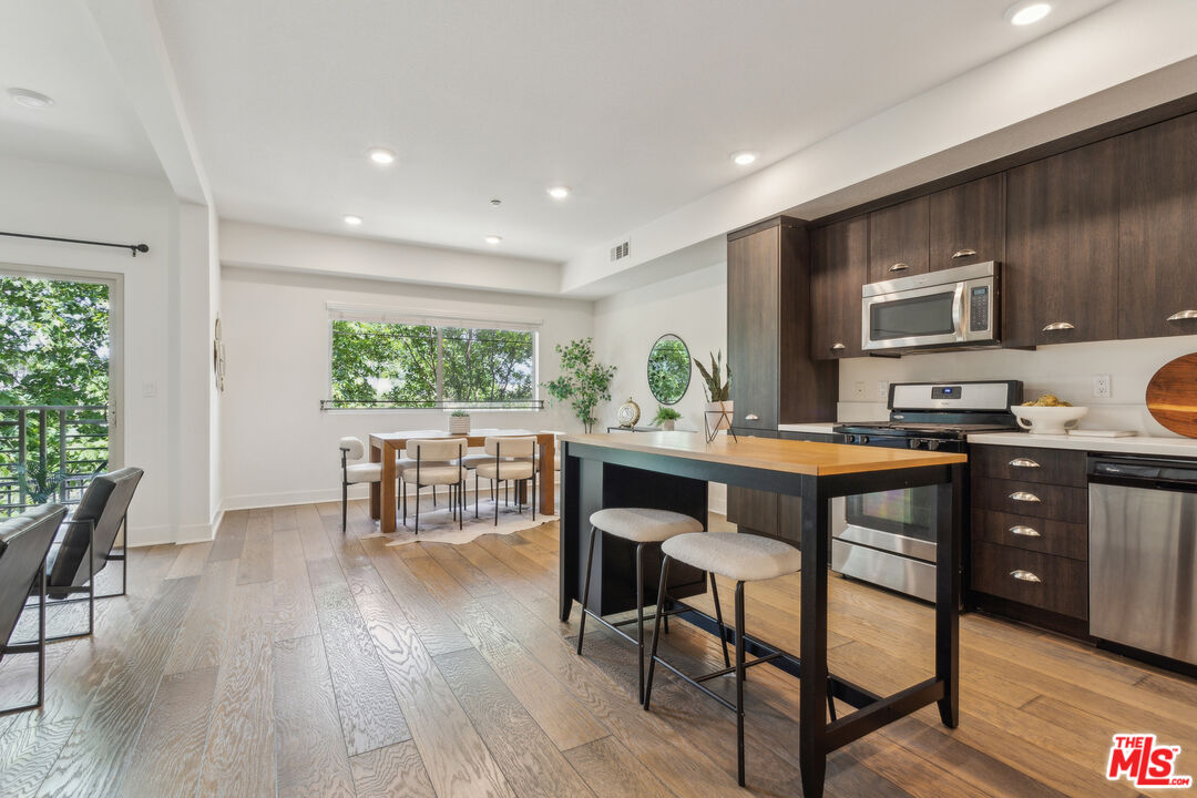 2976 Ripple Place, Unit 103 Los Angeles, CA 90039 - Photo 5 of 16 a kitchen with a table and chairs in it
