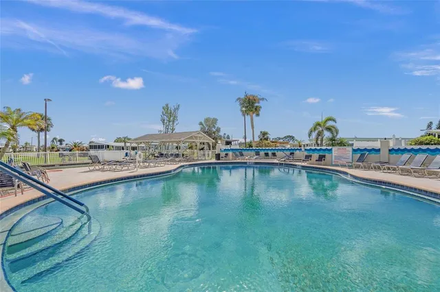 a view of a swimming pool with an outdoor seating