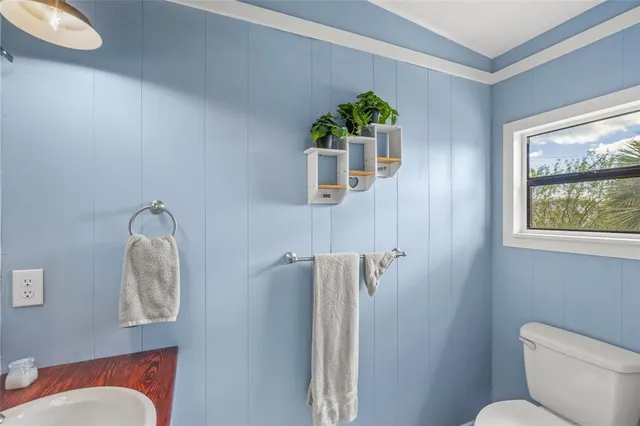 a bedroom with a bed and chair